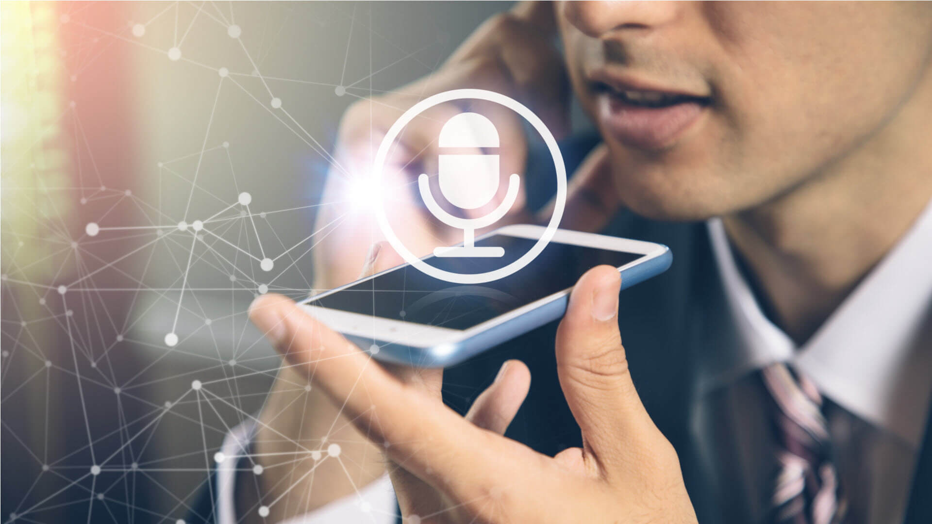 Top 8 Affiliate Marketing Trends You Can't Ignore in 2025 (If You Want to Stay Relevant) 3 Person speaking into a smartphone with a microphone icon overlaid, likely using voice recognition software.