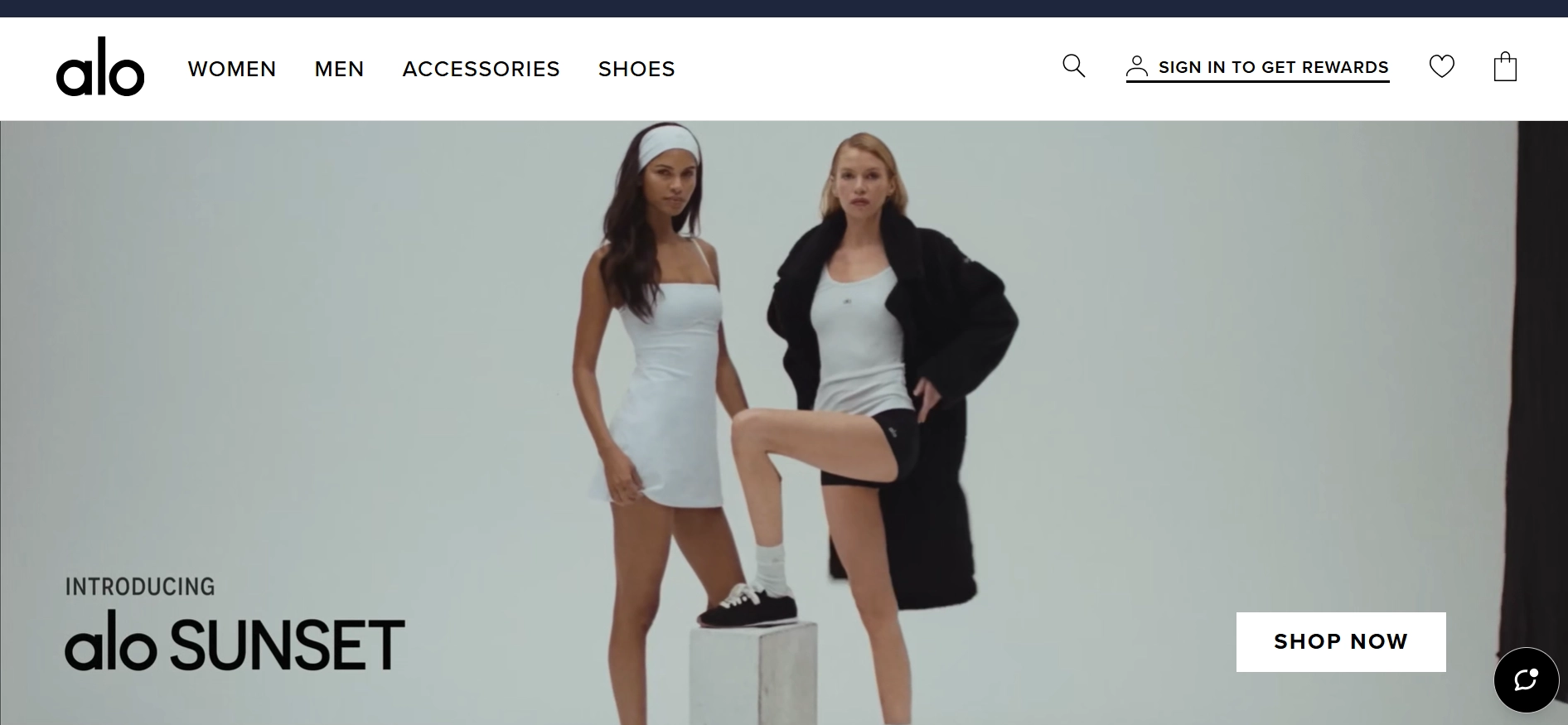 Alo Yoga website banner featuring two models in athletic wear, with text "Introducing Alo Sunset" and a "Shop Now" button.