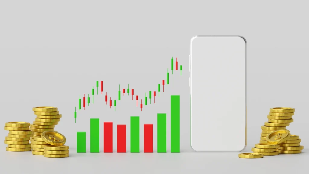 Stacks of gold coins flank a blank smartphone screen next to a financial candlestick and bar chart.